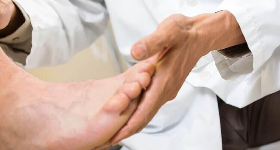 Physician holding a patient's foot.