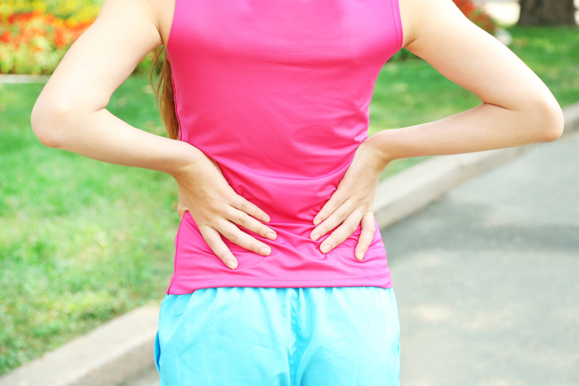 Woman stretching and holding her back.