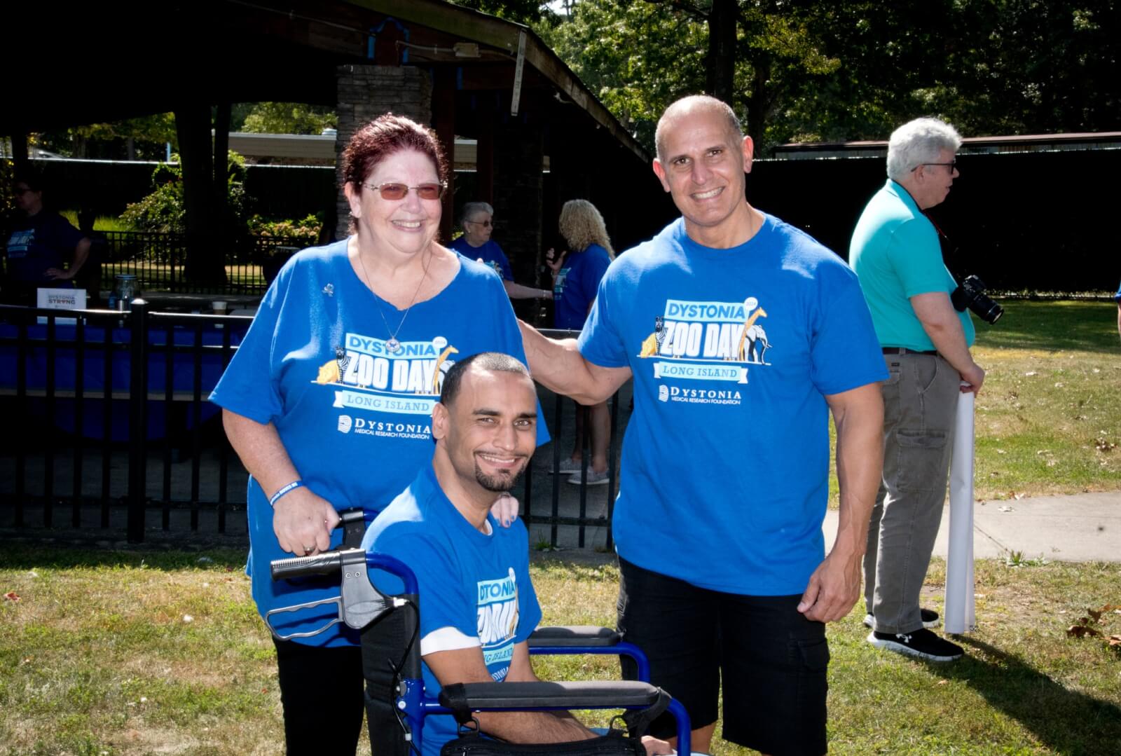 Two people standing one in wheelchair
