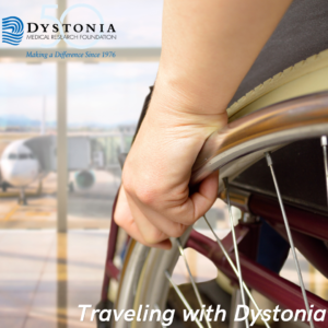 Close-up of a hand gripping a wheelchair wheel, with the Dystonia Medical Research Foundation logo in the upper left and the caption 'Traveling with Dystonia' at the bottom, in an airport setting.