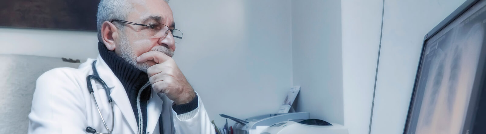 Medical professional looking at screen.