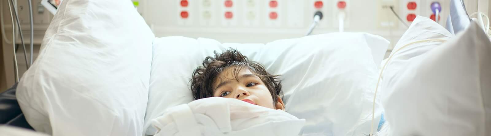 Child resting in a hospital bed.