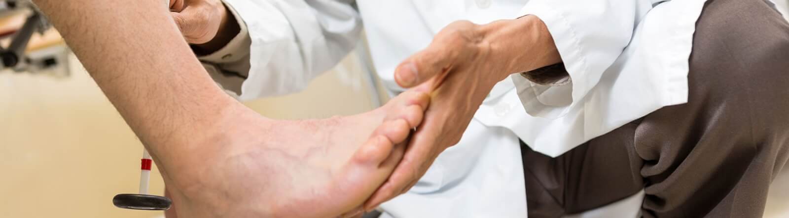 Physician holding a patient's foot.