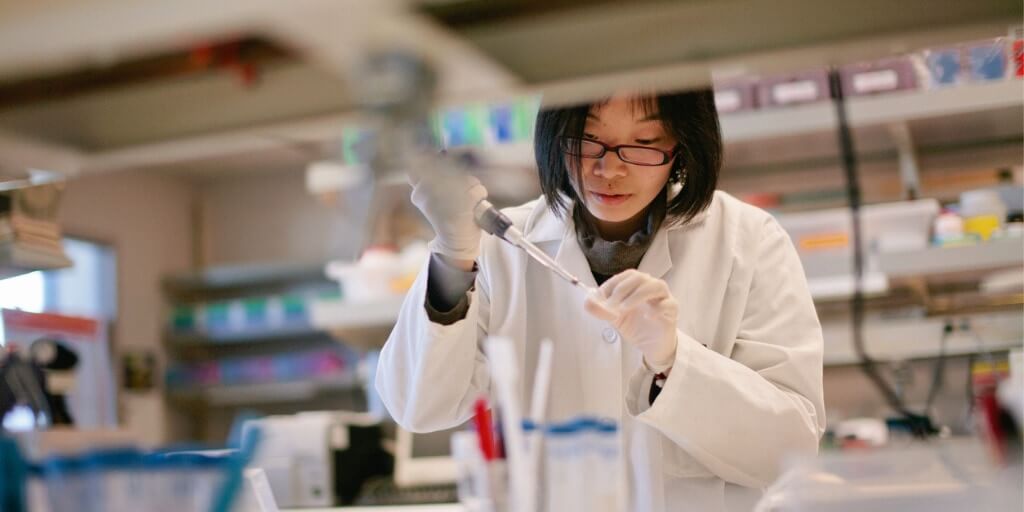 a scientist pipetting at a biomedical laboratory